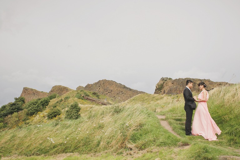 wedding couple looking at each other with hills in the background