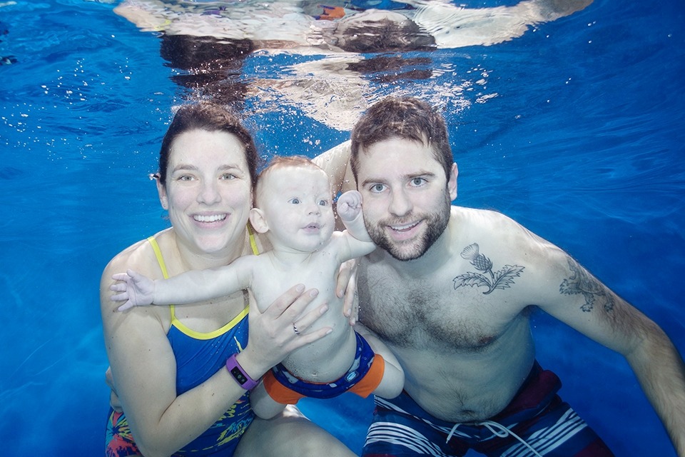 family swimming underwater