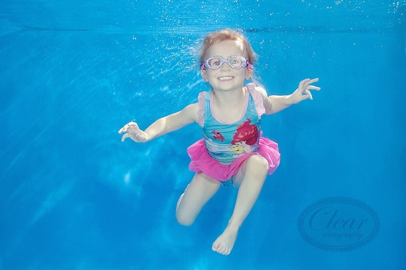 girl smiling underwater