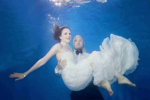 underwater image of bride and groom